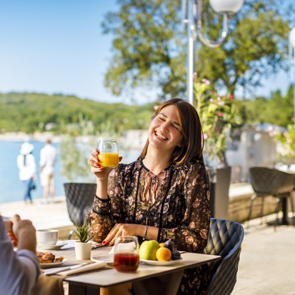Couple having breakfast in a restaurant of a hotel under the Aminess Maradiso Brand
