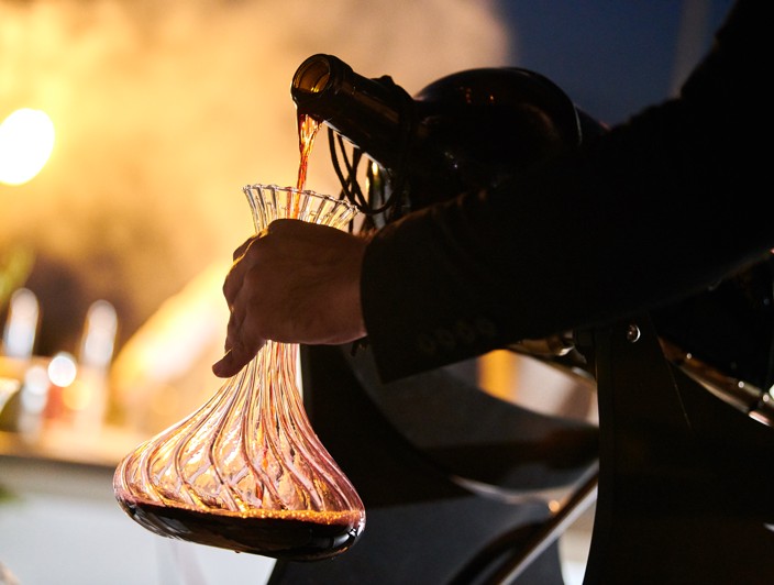 Sommelier pours fine red wine, highlighting Orebic’s rich winemaking culture.