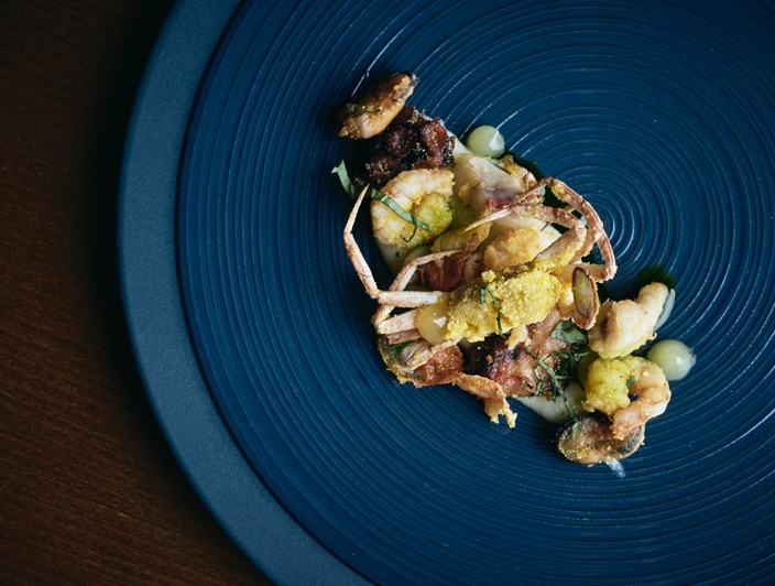 A fish dish served in Aminess restaurants featuring crab as the main ingredient