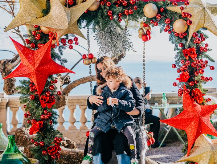Family photo in front of Christmas decor in Opatija.