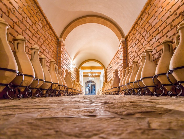 A scenic wine cellar with rows of barrels, showcasing traditional winemaking on Peljesac Peninsula, Orebic.
