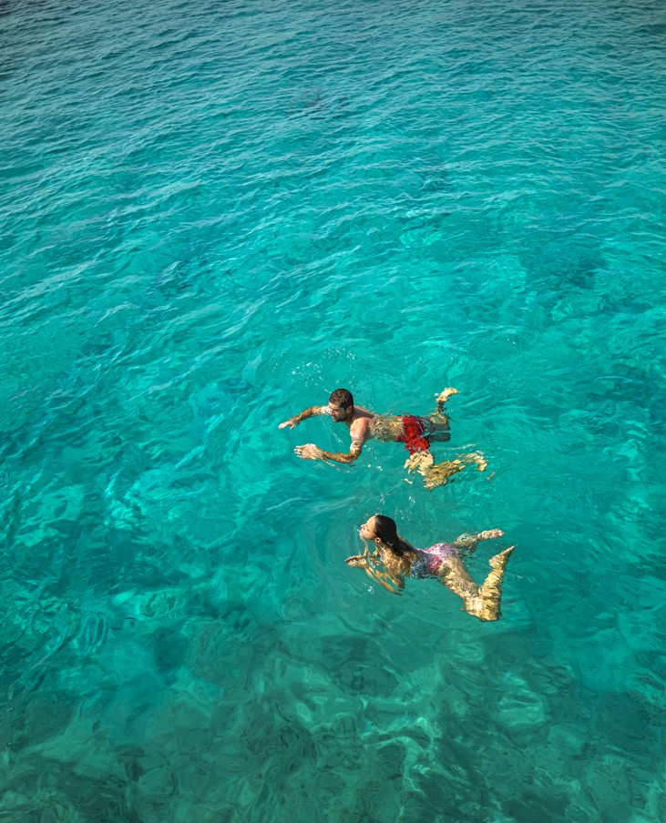 Guests enjoy swimming in crystal-clear turquoise waters near Korcula Island.
