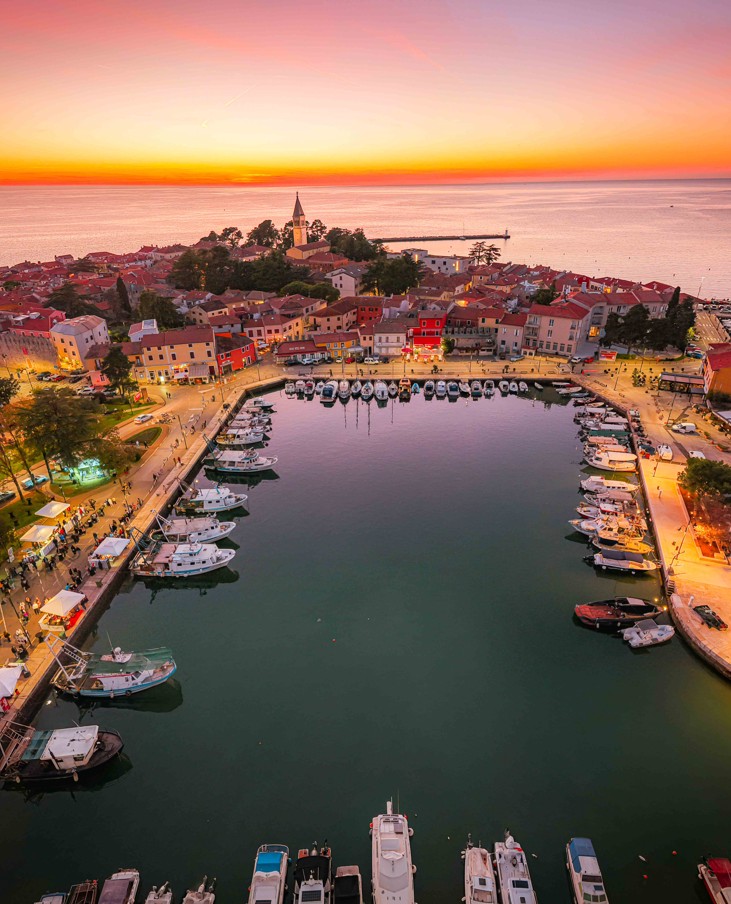 Spring sunset over old town harbor with boats and sea view