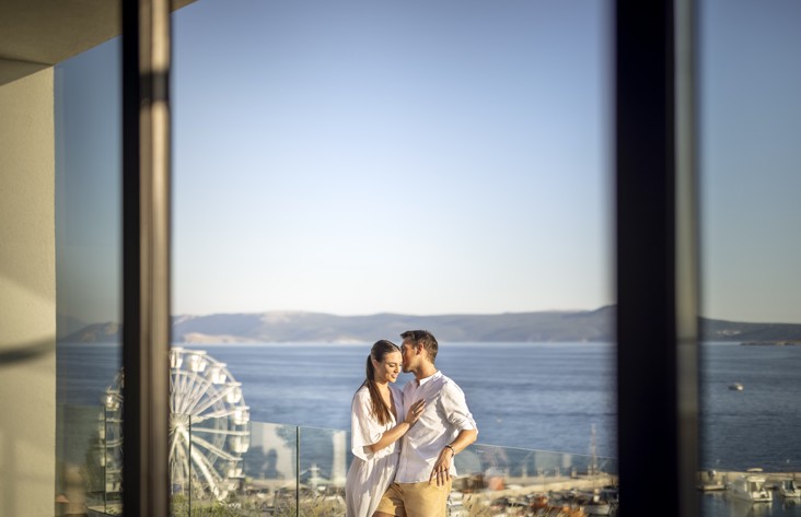 Romantic couple enjoying the view from the wellness terrace at Aminess Younique Narrivi Hotel.