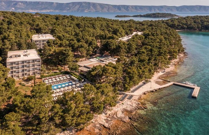 Panoramic view of Aminess Younique Senses Resort on Hvar island, nestled by the sea and surrounded by dense pine forest