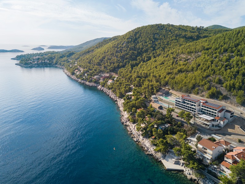 Aerial view of the coastline and natural surroundings near Aminess Alfir Resort by the crystal-clear sea