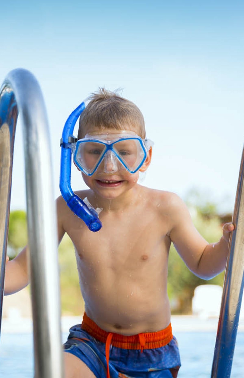 Kid having fun at the pool of a hotel under the Aminess Maradiso Brand