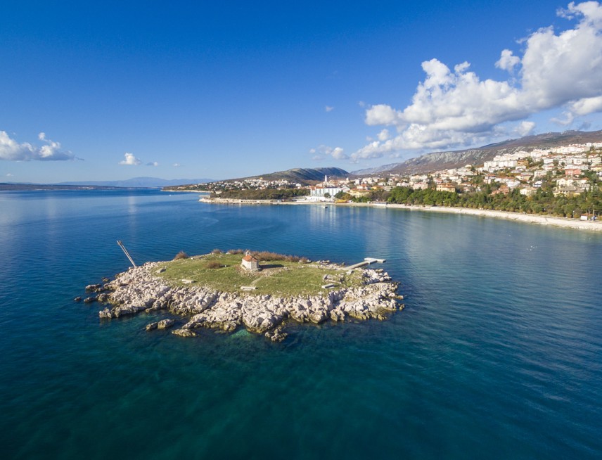Aerial view of an island in front of the city of Novi Vinodolski