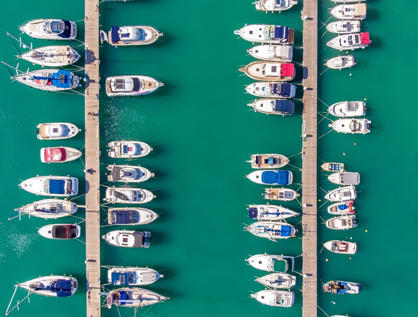 Seaside view of the marina and coastal town of Novi Vinodolski, Croatia, with boats and red rooftops.