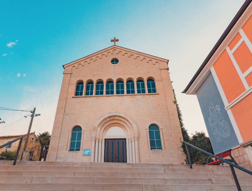 Saint Anthony of Padua Church in Crikvenica, Croatia, featuring a simple facade and surrounding buildings.