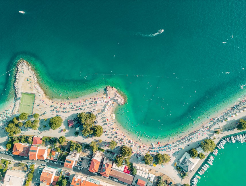 Aerial view of the coastline and beach with turquoise waters in Crikvenica, Croatia.