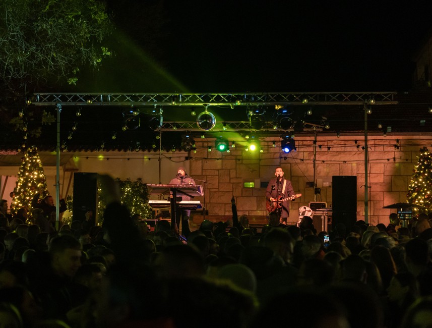 A summer concert on Brač Island, Croatia, with a lively crowd enjoying live music outdoors, surrounded by the island's scenic atmosphere.