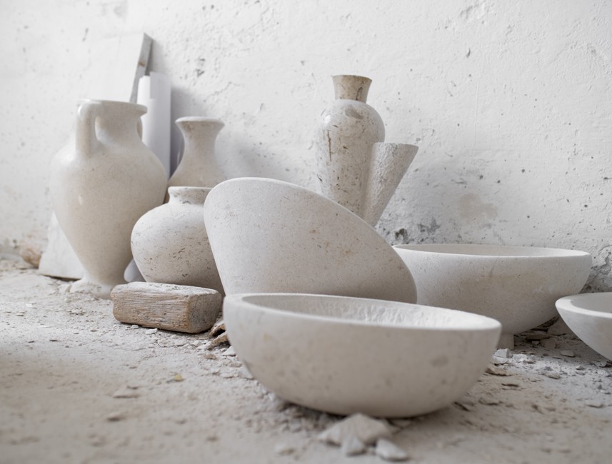 A collection of stone vases and plates on Brač Island, Croatia, showcasing traditional stone craftsmanship and artistry.