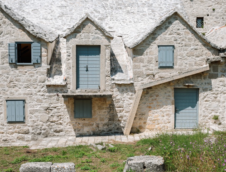 Traditional stone houses on Brač Island, Croatia, featuring rustic architecture, narrow alleys, and a charming Mediterranean atmosphere.
