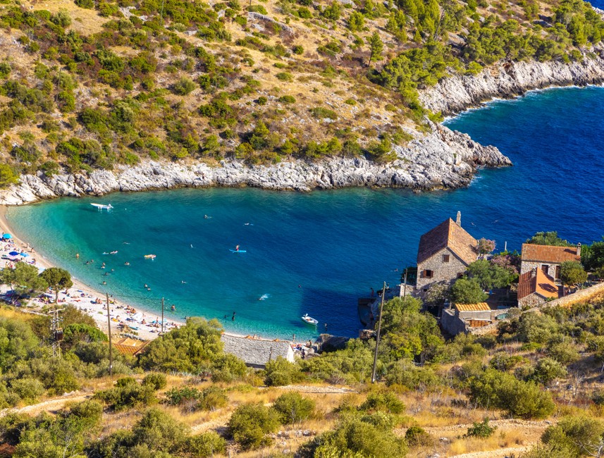 Dobovica Beach on Hvar Island, Croatia, featuring turquoise Adriatic waters, a secluded pebble shoreline, and untouched Mediterranean nature – Aminess destination travel.