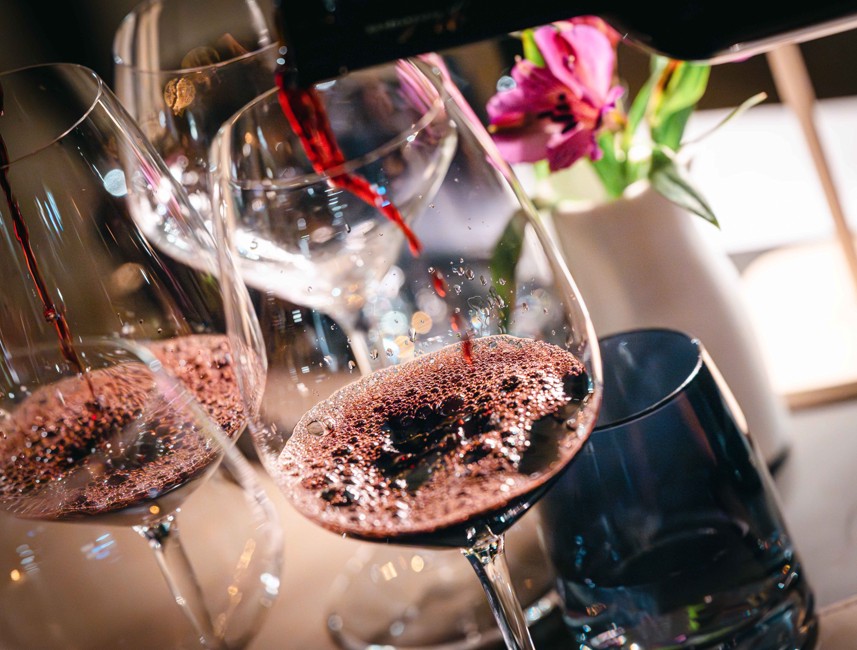 Red wine glasses being filled at a fine dining experience in Crikvenica, Croatia.