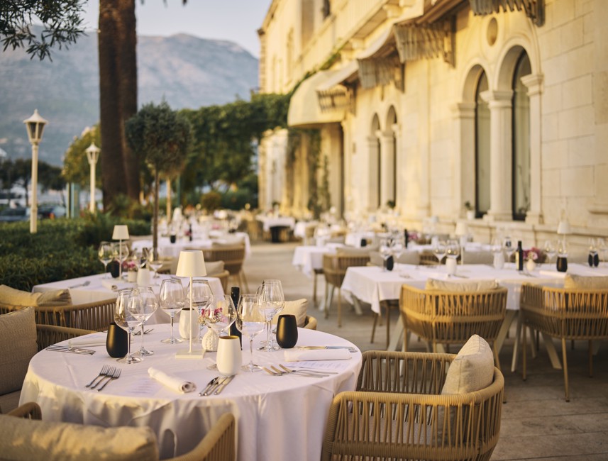 Elegant and luxury table terrace setting at the 7 Seas Restaurant & Bar within historical Aminess Korcula Heritage Hotel during the golden hour