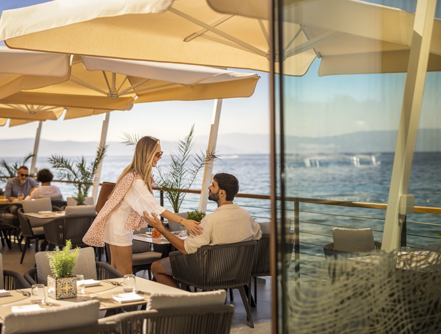 A couple sharing a moment on the terrace overlooking the Adriatic at 7 Seas Restaurant & Bar.