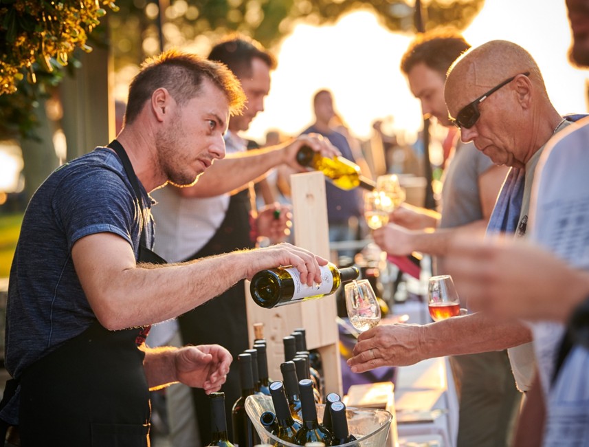 Događaj degustacije vina u Novigradu s gostima koji isprobavaju lokalno vino od vlasnika lokalne vinoteke