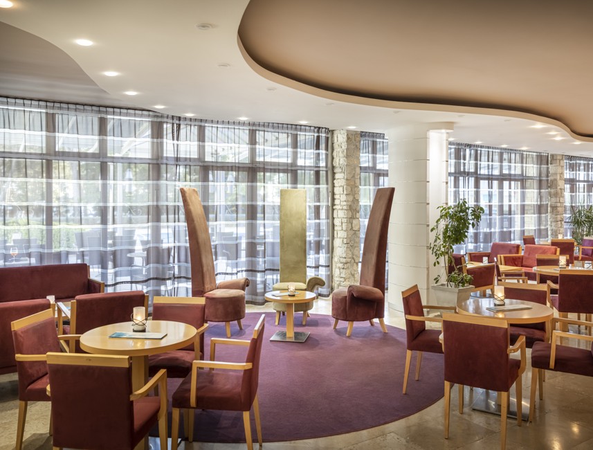 Lounge area with warm-toned seating at Aminess Maradiso Hotel Laguna, Novigrad