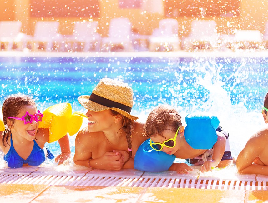 Family enjoying a sunny day by the pool with children playing in Novi Vinodolski, Croatia.