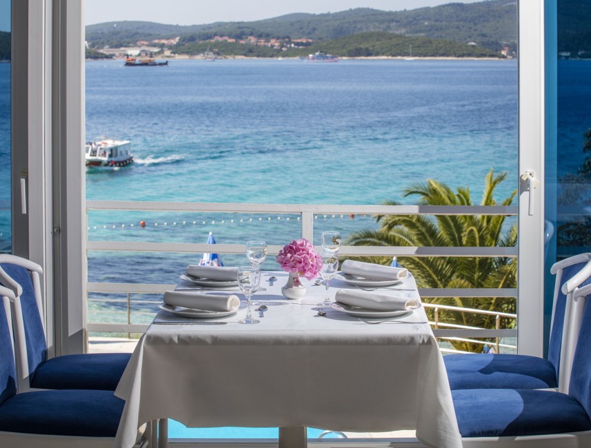 A bright and classic restaurant interior with a stunning sea views at Maradiso Orsan by Aminess Hotel  on Peljesac peninsula in Croatia.
