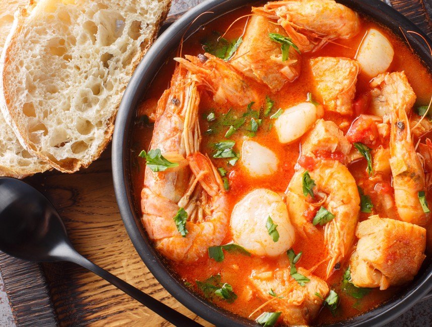 Traditional seafood stew with shrimp, fish, and bread served in Crikvenica, Croatia.