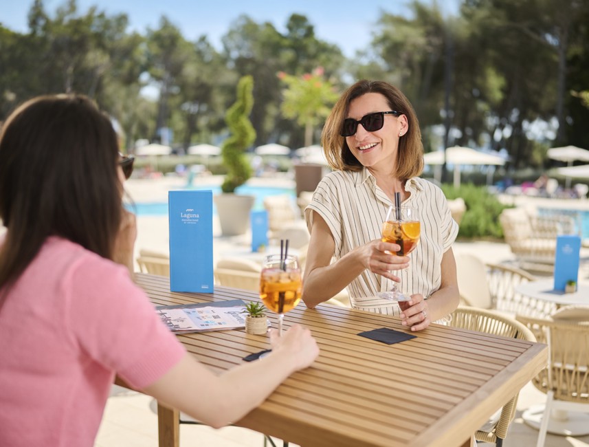 Guests enjoying cocktails on the lobby bar terrace of Laguna Maradiso Hotel by Aminess
