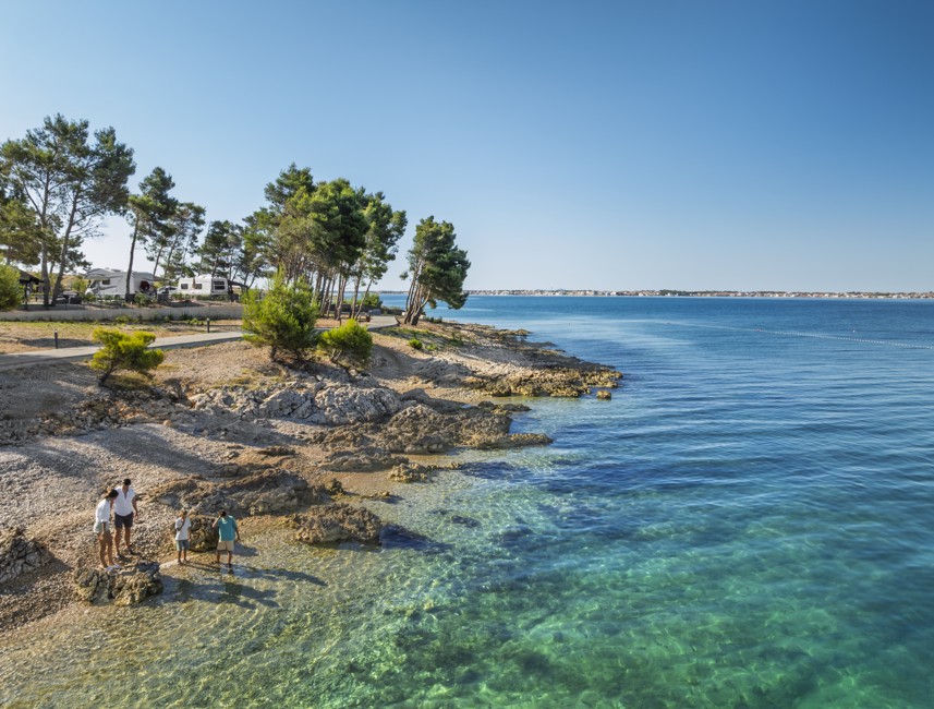 Gasten genieten van het strand met kristalheldere zee in Avalona Resort