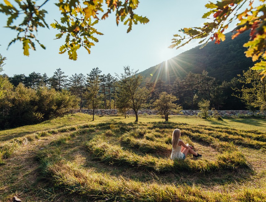 Mediterranean Labyrinth of love near Crikvenica, with a serene natural setting and sunlight filtering through the trees.