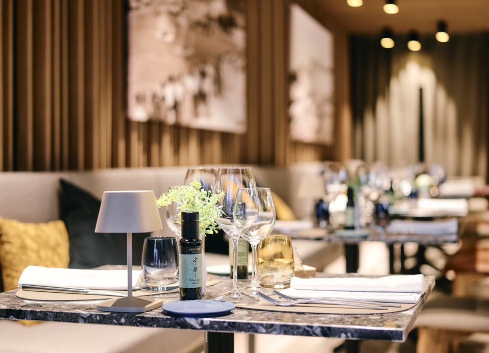 Elegant sitting area with table settings at Aminess Younique Narrivi Hotel restaurant.