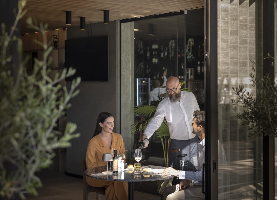 Couple enjoying a meal at Half8 restaurant at Aminess Younique Narrivi Hotel.