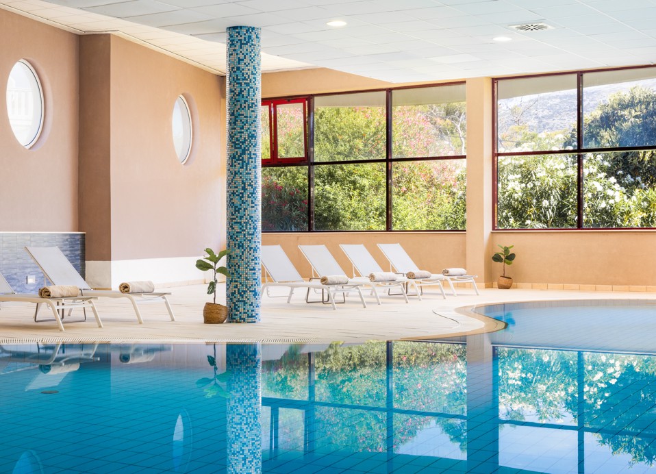 Indoor pool at Maradiso Marko Polo by Aminessl in Korcula with a relaxing atmosphere, cascading water features, and large windows for natural light.