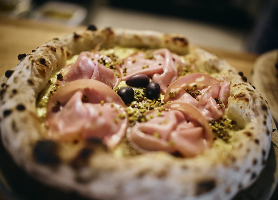 Pizza with ham, olives and pistachios at Kadoor Restaurant in Karlovac.