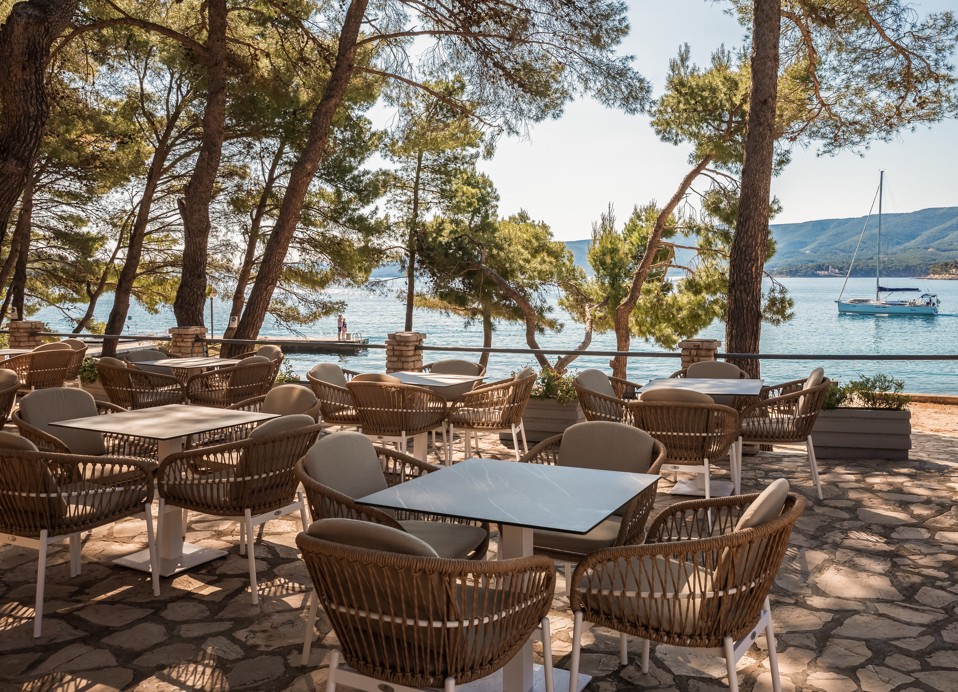 Terrace bar at Aminess Younique Senses Resort on Hvar Island with sea view through pine trees