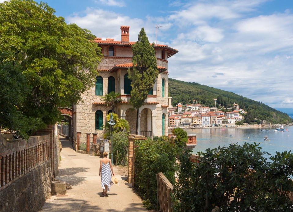 Walking along the Lungomare past a historic villa with sea views