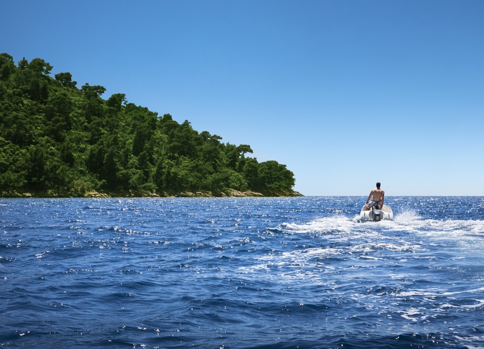 A person riding a jet ski on the open water near near Port9 Planet Camping by Aminess.