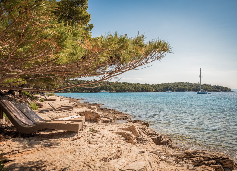 Crystal-clear sea and beach by Aminess Younique Senses Resort Hvar