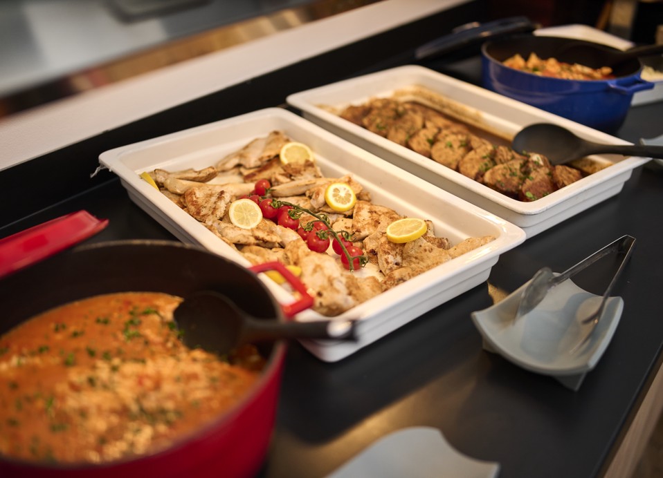 Warm dishes on display at the buffet in Restaurant Rondela, showcasing deliciously prepared meals in a cozy setting at Aminess Maradiso Casa Bellevue.