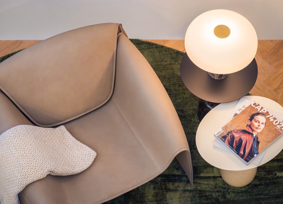 Armchair and table lamp in a Deluxe Duplex Suite at Younique Korcula Heritage Hotel.