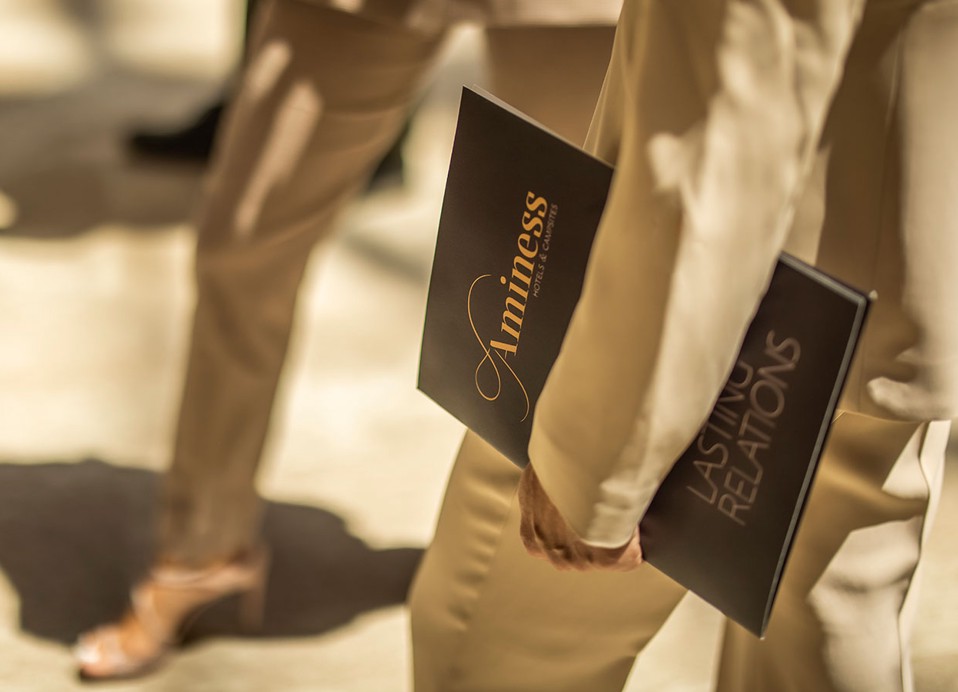 A woman holds an Aminess facle in her hand at Aminess Laurel Khalani hotel..