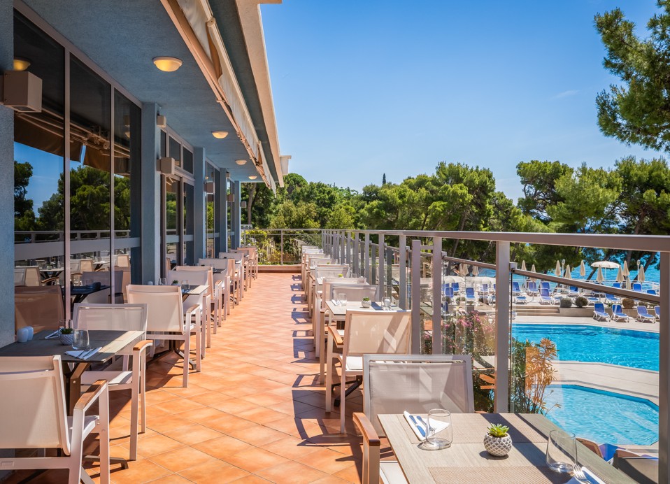 Restaurant terrace at Aminess Vival Grand Azur Hotel overlooking the pool.