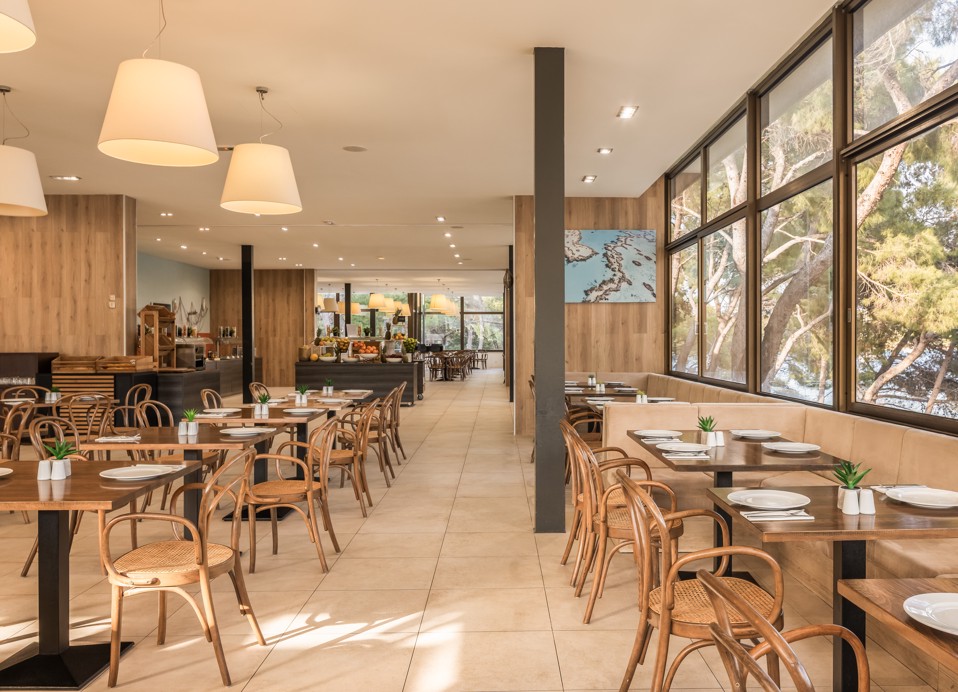 Interior of Restaurant Unico at Aminess Younique Senses Resort on Hvar Island with a view of the pine forest