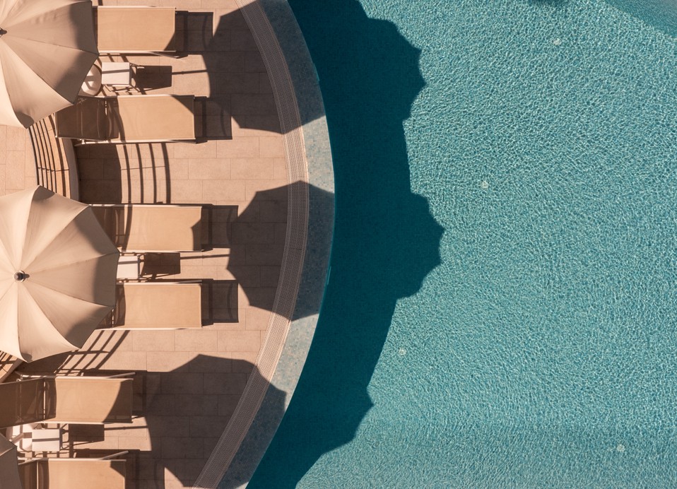 Sun bed are by the hotel pool, pine trees and a beach in Aminess Maradiso Casa Bellevue.