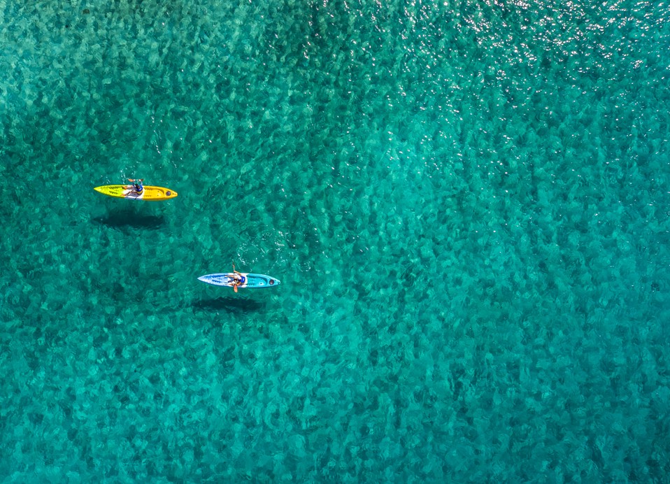 Kayaking through the calm waters near Port9 Planet Camping by Aminess.