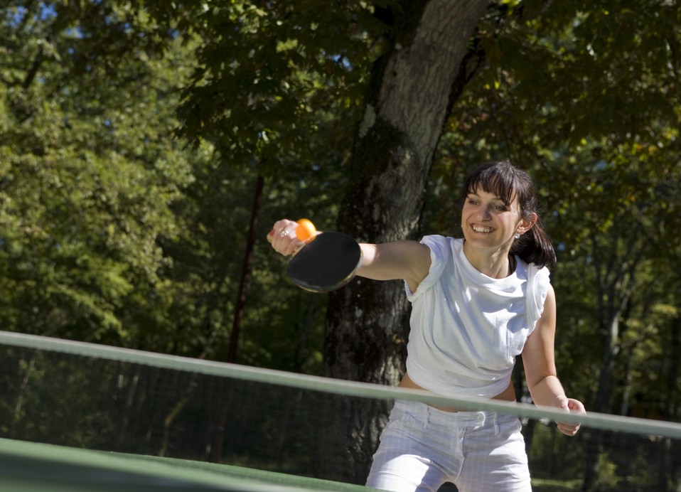 Guests having fun playing table tennis within resort near Holiday Homes at Port9 Planet Camping by Aminess.