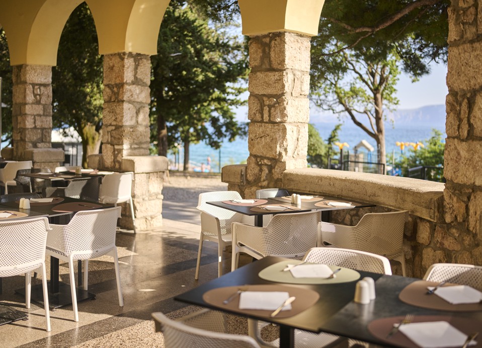 Romantična jedilna terasa v senci kamnitih lokov s pogledom na morje v Novem Vinodolskem.