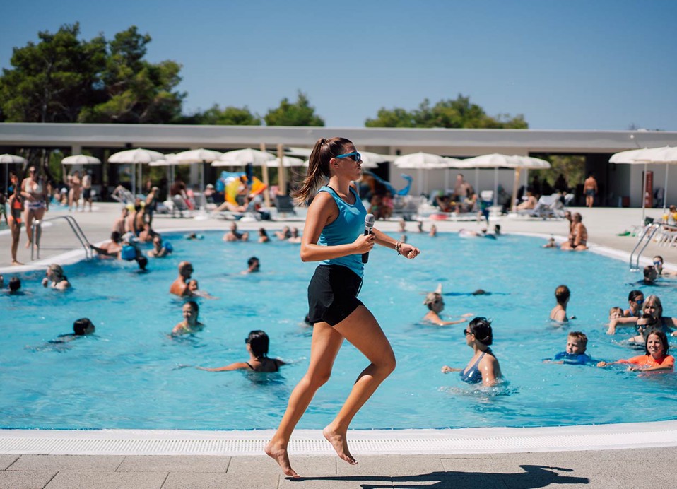 An animator entertains guests in the pool at Aminess Style Camping Avalona resort.