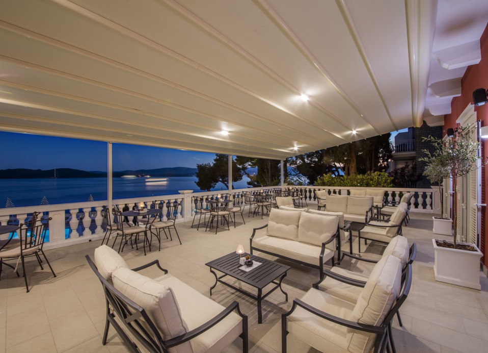 A cozy night scene at the hotel's aperitif bar terrace, perfect for a romantic drink near Aminess Maradiso Casa Bellevue.