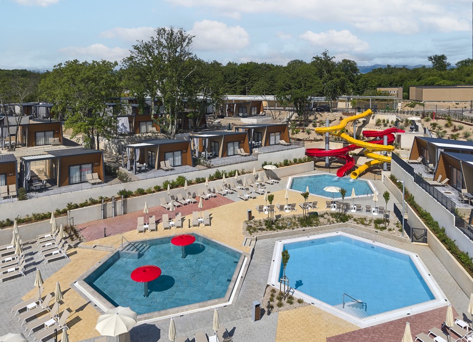 Pool complex with water slides and mobile homes at Aminess Atea Camping Resort.